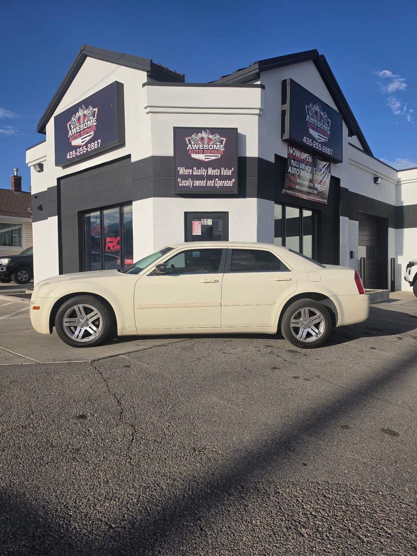 The 2006 Chrysler 300 parked in front of Awesome Auto Repair in Tooele